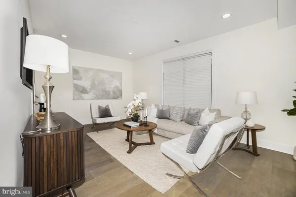 a living room with furniture a rug and a chandelier