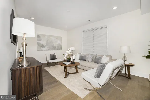 a living room with furniture a rug and a chandelier