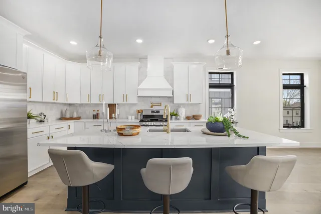 a kitchen with granite countertop white cabinets and chairs