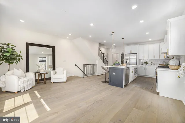 a living room with furniture and kitchen view