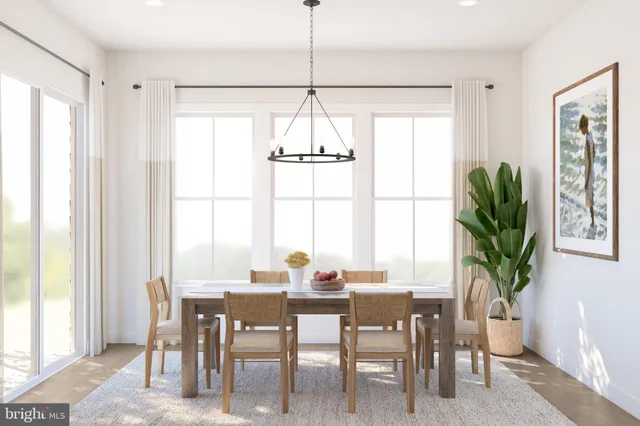a dining room with furniture a chandelier and wooden floor