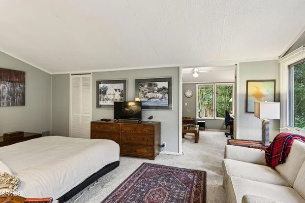 a bedroom with a large bed and a couch