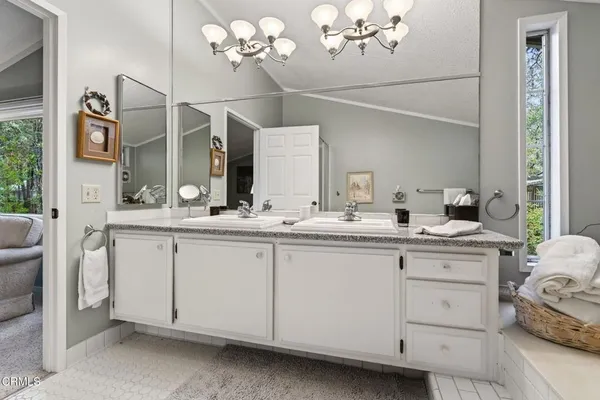 a bathroom with a sink vanity and mirror