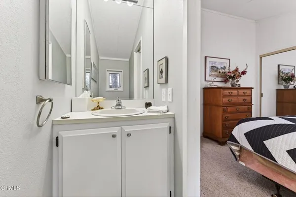 a en suite bathroom with a double vanity sink a mirror and a shower