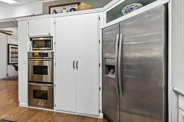 a kitchen with metallic refrigerator freezer and a dishwasher