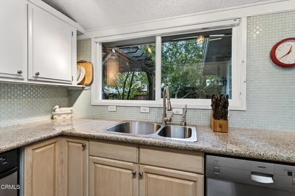 a kitchen with granite countertop a sink and a window