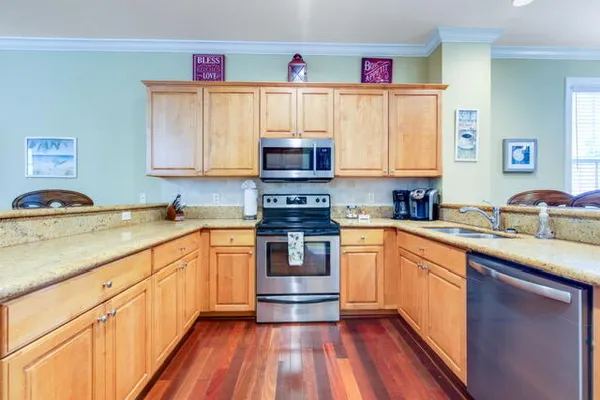 a kitchen with stainless steel appliances granite countertop a sink and cabinets