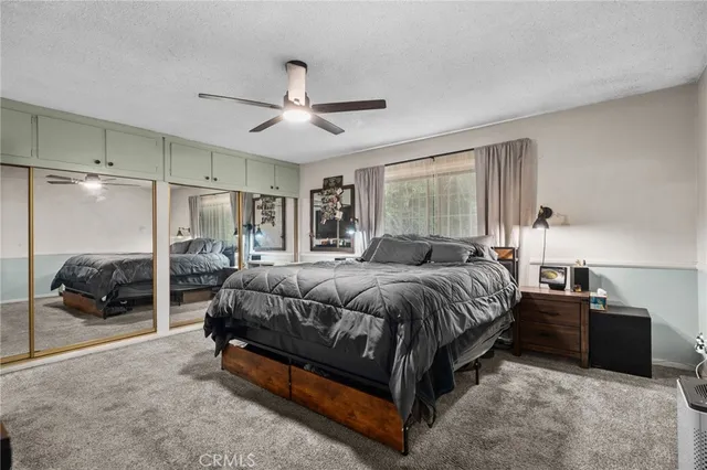 a spacious bedroom with a bed and a large window