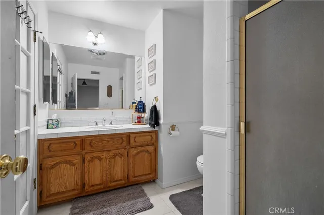 a spacious bathroom with a double vanity sink and a mirror