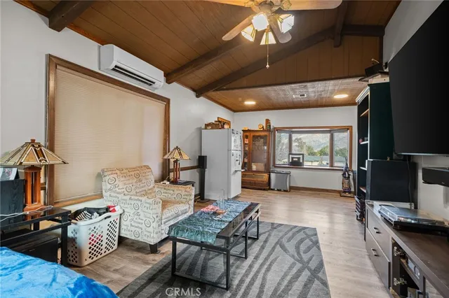 a patio with table and chairs and potted plants