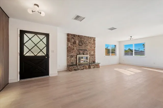 an empty room with windows and closet