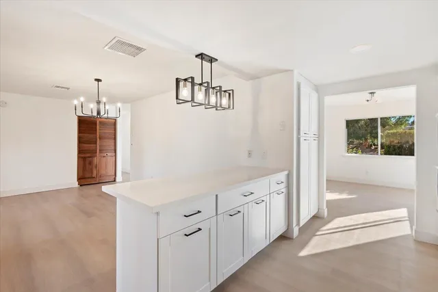 a view of a kitchen with a sink cabinets and wooden floor