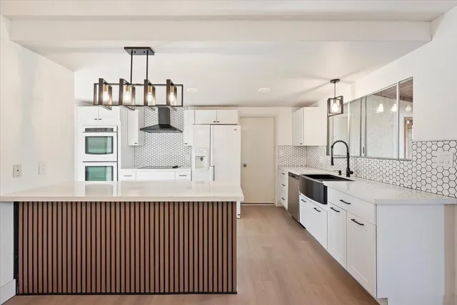 a view of a kitchen with a sink and cabinet area
