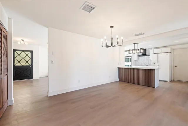 a view of an entryway with wooden floor