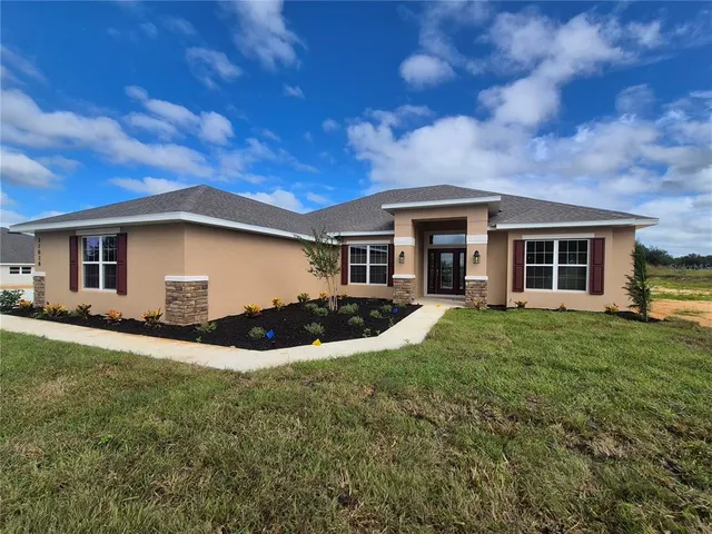 a view of a house with a backyard