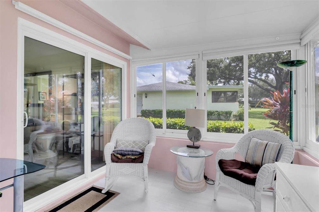 2828 Sherbrooke Lane, Unit C Palm Harbor, FL 34684 - Photo 15 of 40 a living room with furniture and a floor to ceiling window