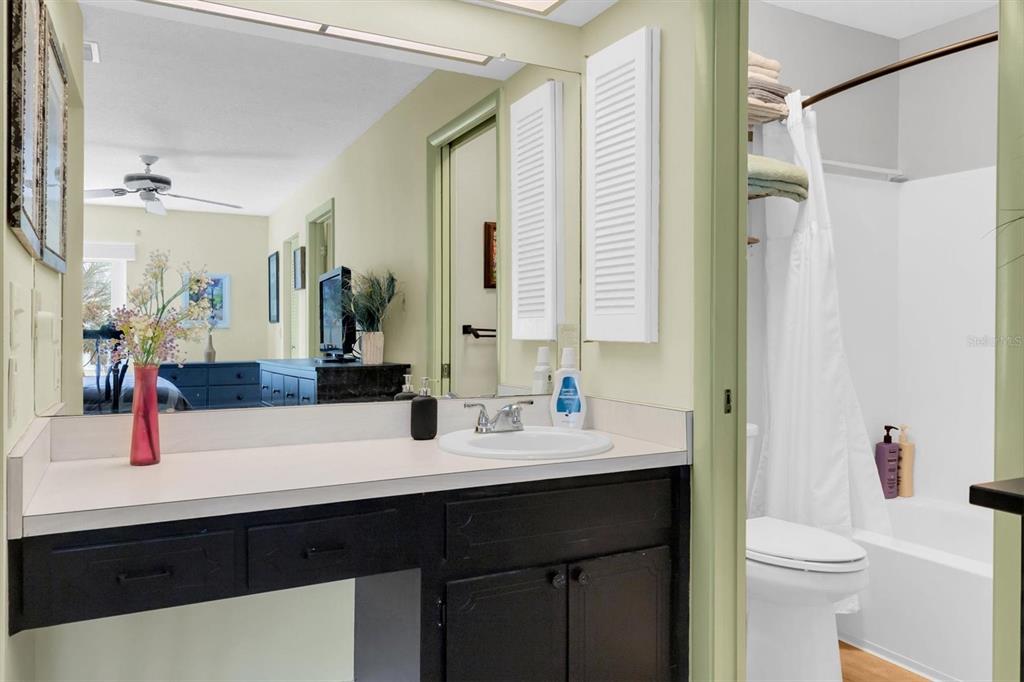 2828 Sherbrooke Lane, Unit C Palm Harbor, FL 34684 - Photo 17 of 40 a bathroom with a double vanity sink toilet and shower