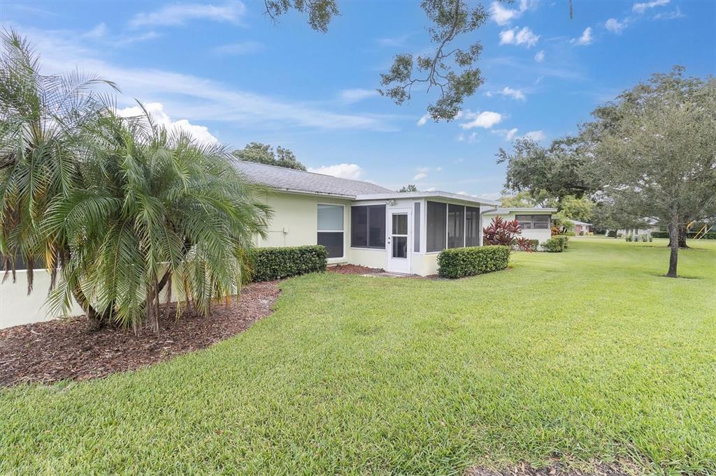 2828 Sherbrooke Lane, Unit C Palm Harbor, FL 34684 - Photo 21 of 40 a view of a house with a backyard