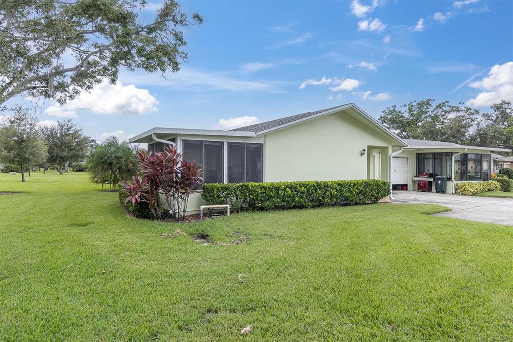 2828 Sherbrooke Lane, Unit C Palm Harbor, FL 34684 - Photo 22 of 40 a front view of a house with garden