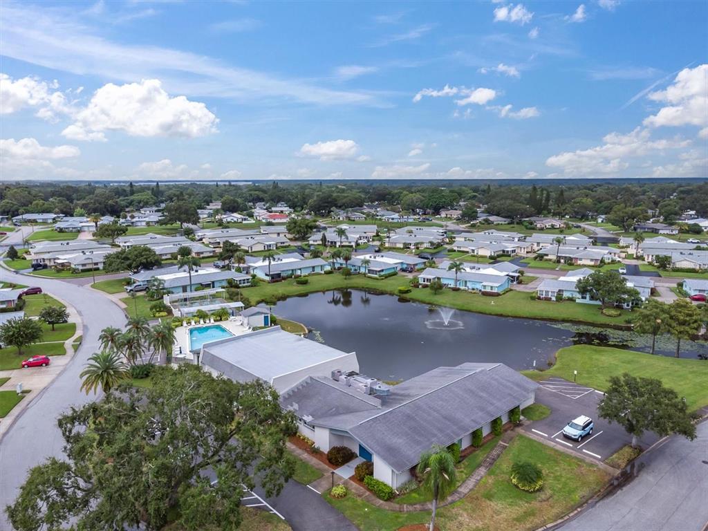 2828 Sherbrooke Lane, Unit C Palm Harbor, FL 34684 - Photo 30 of 40 an aerial view of a house with a lake view