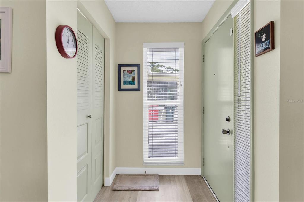 2828 Sherbrooke Lane, Unit C Palm Harbor, FL 34684 - Photo 4 of 40 a view of an entryway with wooden floor