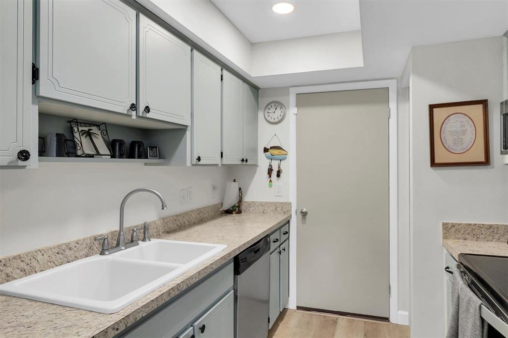 2828 Sherbrooke Lane, Unit C Palm Harbor, FL 34684 - Photo 9 of 40 a kitchen with stainless steel appliances granite countertop a sink stove and cabinets