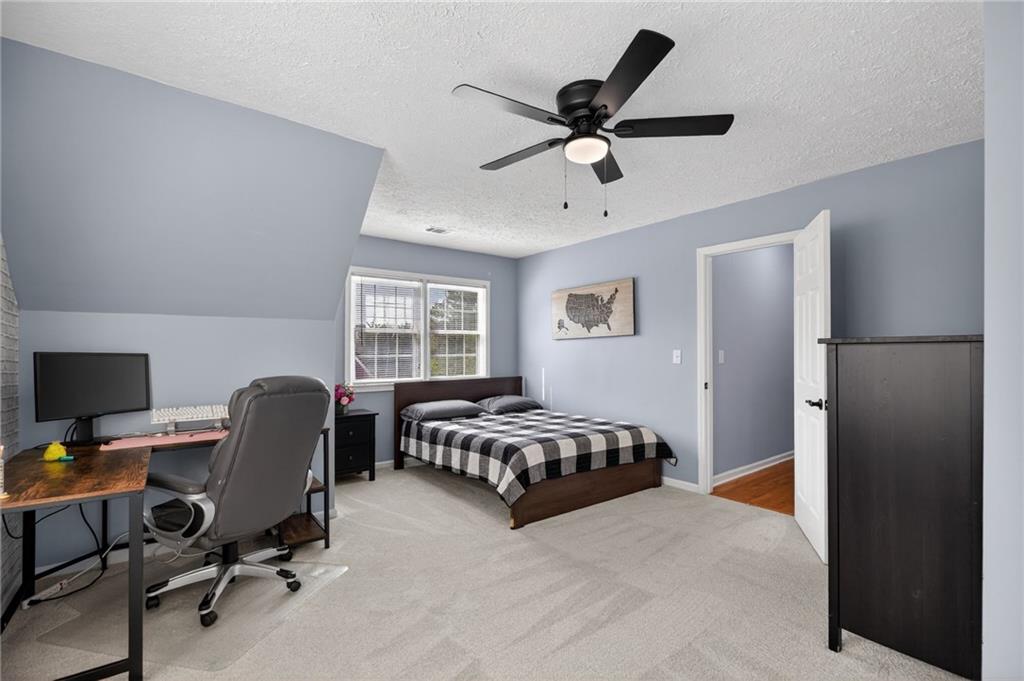 53 Crestview Drive Dallas, GA 30157 - Photo 24 of 46 a bedroom with a bed a desk and chair with a window
