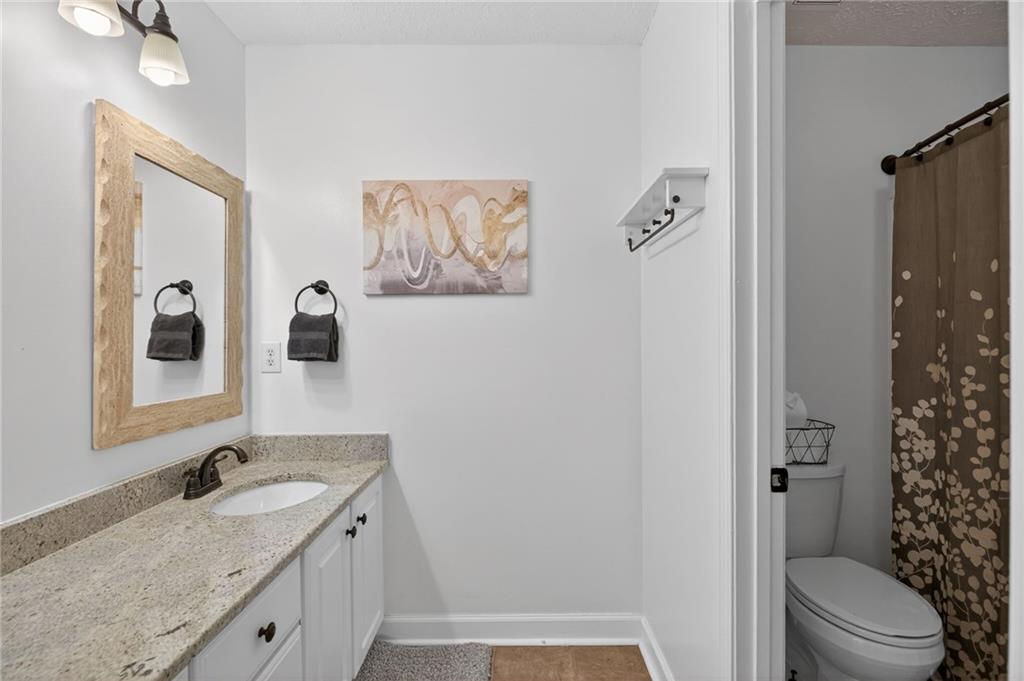 53 Crestview Drive Dallas, GA 30157 - Photo 27 of 46 a bathroom with a granite countertop sink toilet and shower
