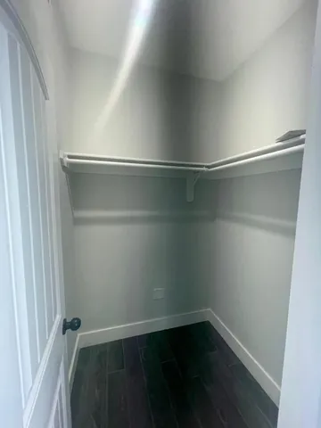 a empty closet with wooden floor