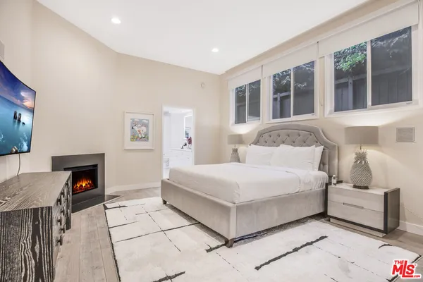 a bedroom with a bed and a tv