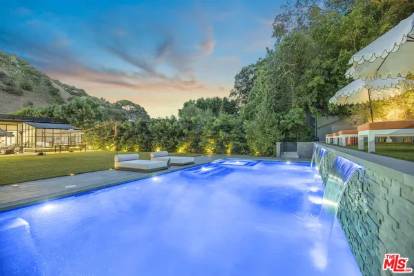 a view of a swimming pool with an outdoor seating and a yard