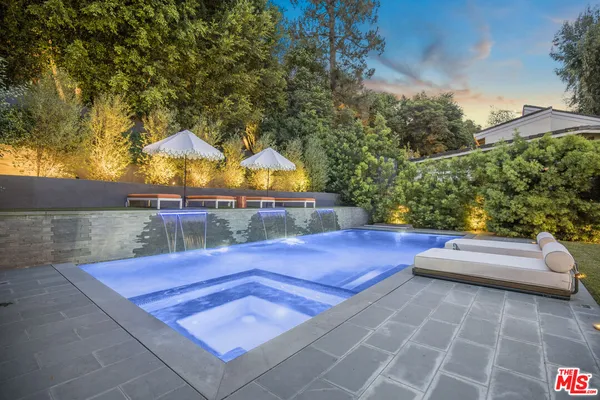 swimming pool view with a seating space