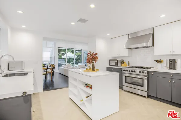 a kitchen with a stove and cabinets