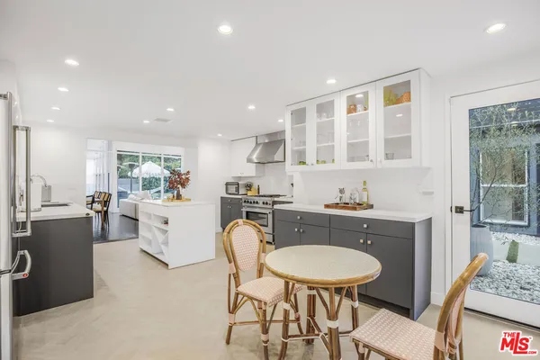 a kitchen with granite countertop a sink and cabinets