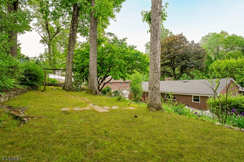 106 Division Avenue Summit, NJ 07901 - Photo 37 of 38 a backyard of a house with yard and outdoor seating