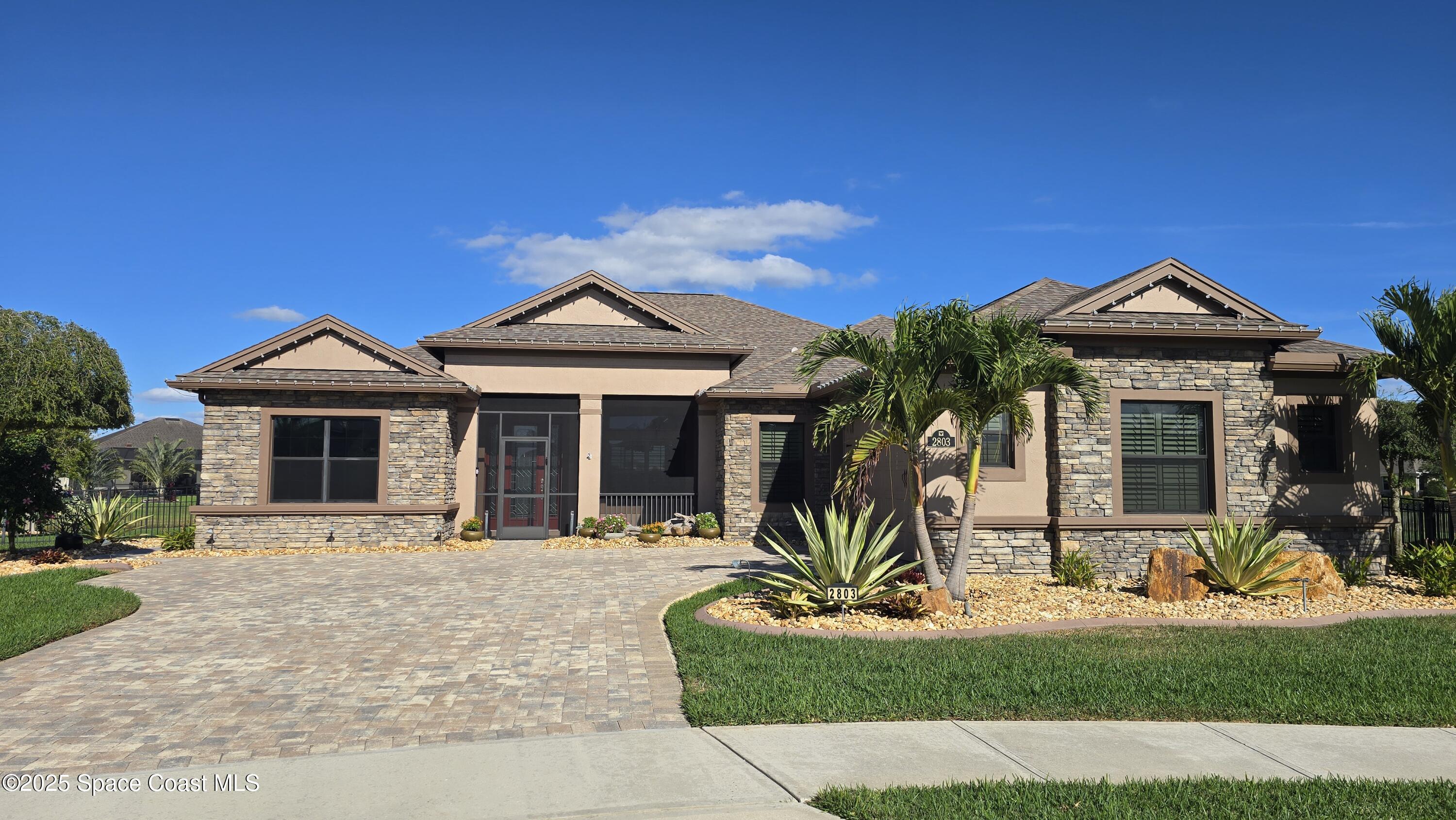 2803 Agilny Lane Melbourne, FL 32940 - Photo 2 of 65 a front view of a house with a yard