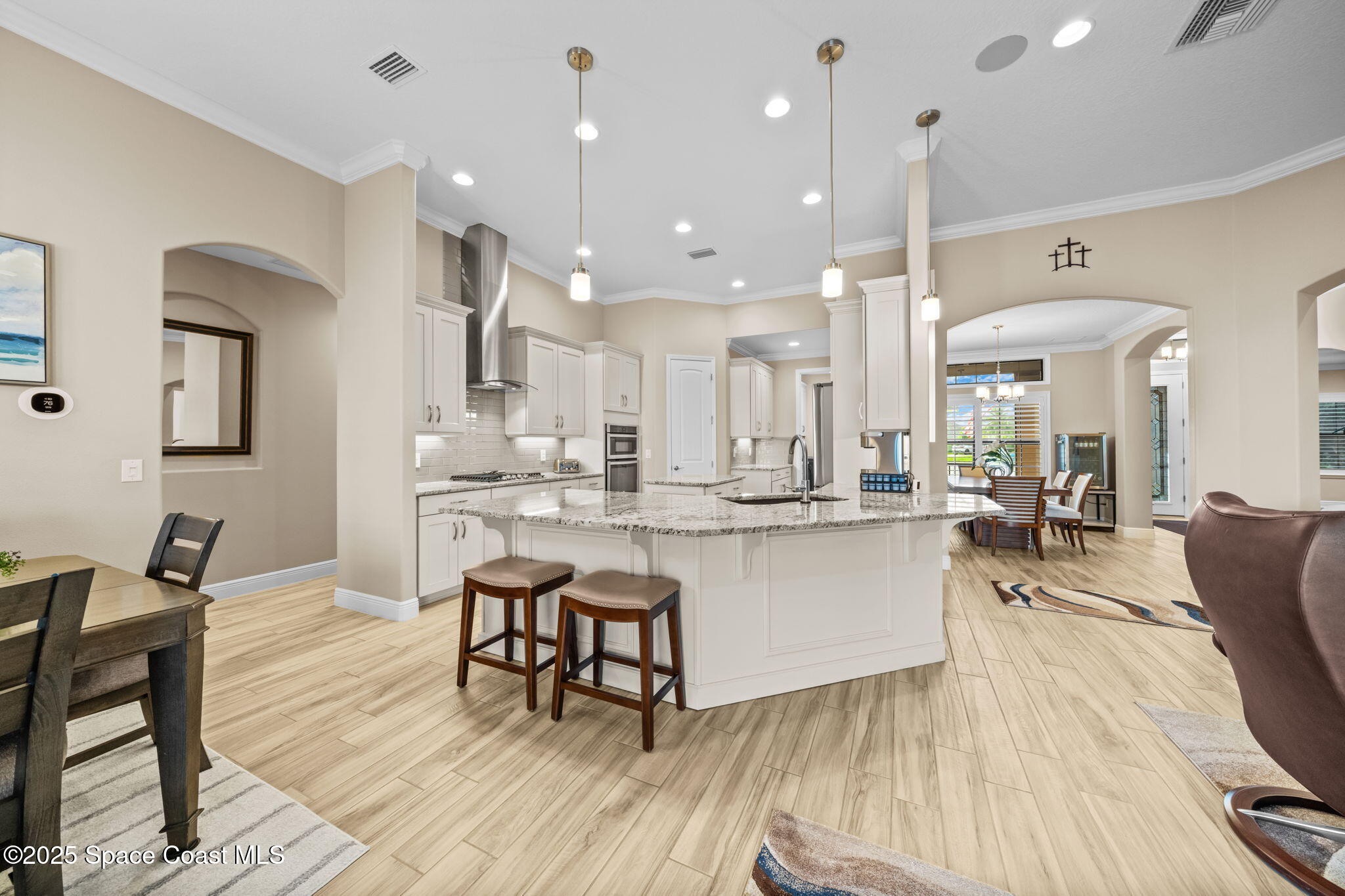 2803 Agilny Lane Melbourne, FL 32940 - Photo 23 of 65 a large kitchen with a table and chairs