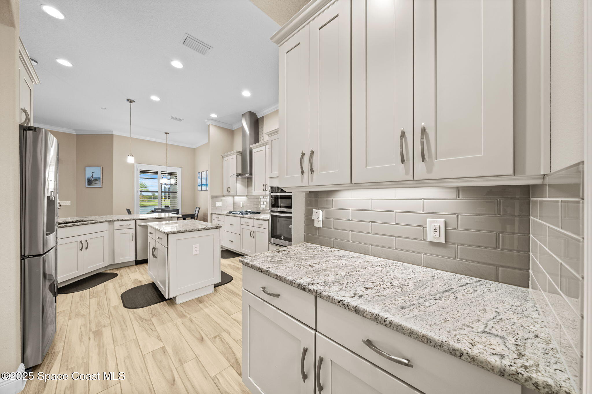 2803 Agilny Lane Melbourne, FL 32940 - Photo 26 of 65 a kitchen with white cabinets and sink