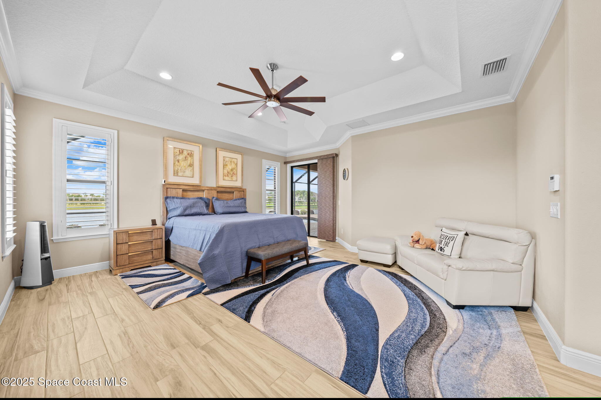 2803 Agilny Lane Melbourne, FL 32940 - Photo 29 of 65 a bedroom with a bed couch and a window