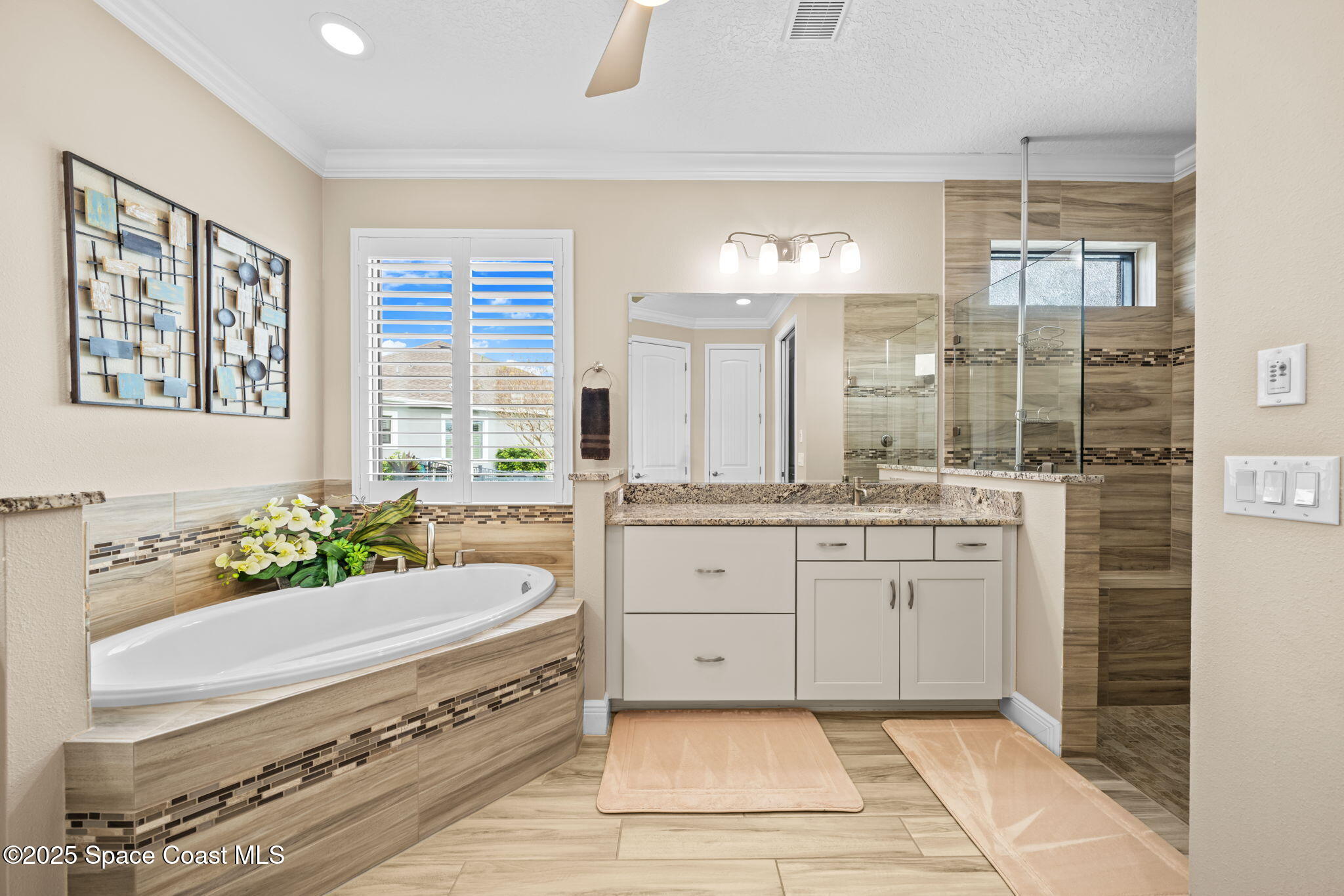 2803 Agilny Lane Melbourne, FL 32940 - Photo 33 of 65 a spacious bathroom with a tub sink and mirror