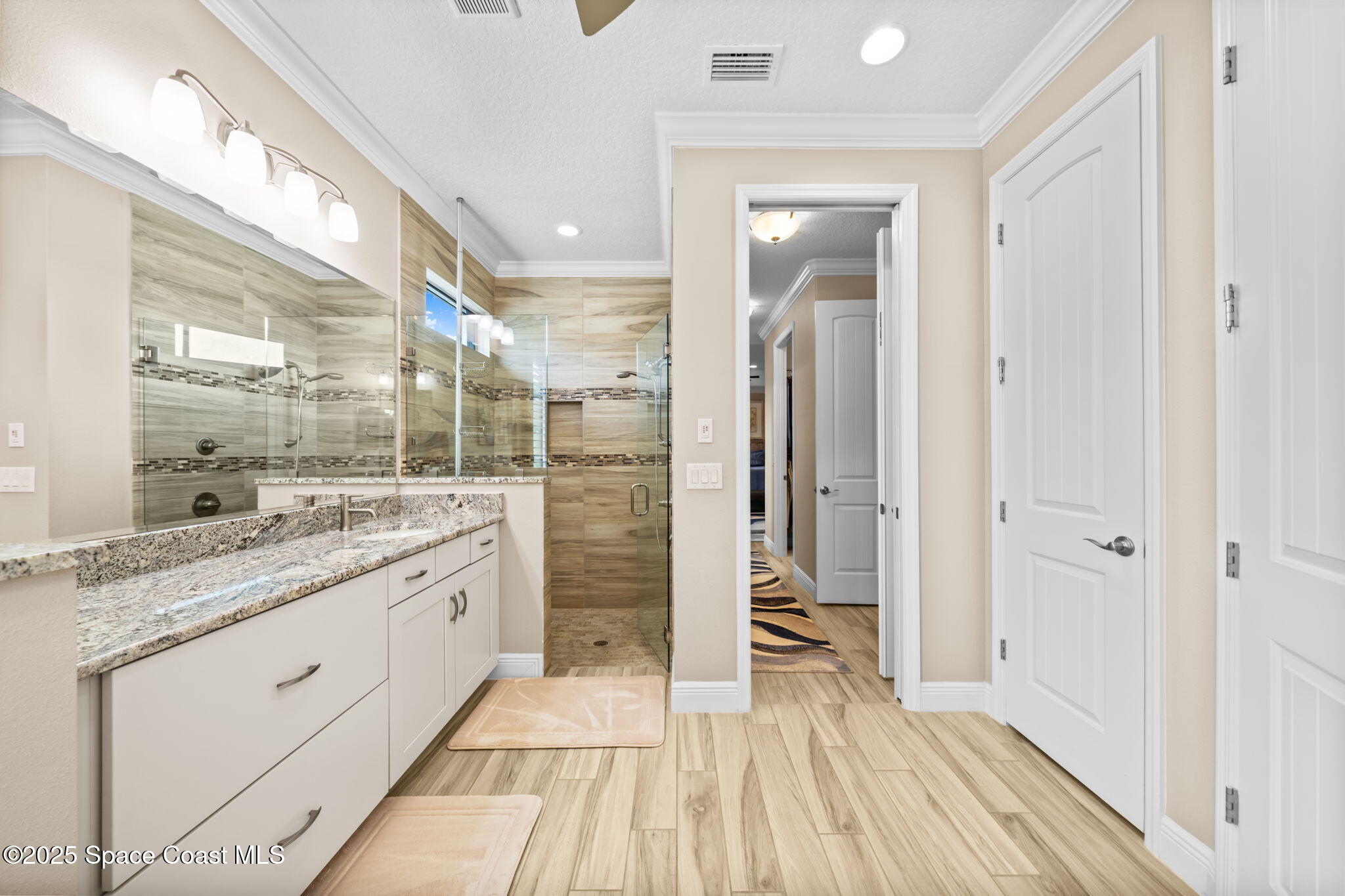 2803 Agilny Lane Melbourne, FL 32940 - Photo 34 of 65 a bathroom with a granite countertop sink toilet and shower