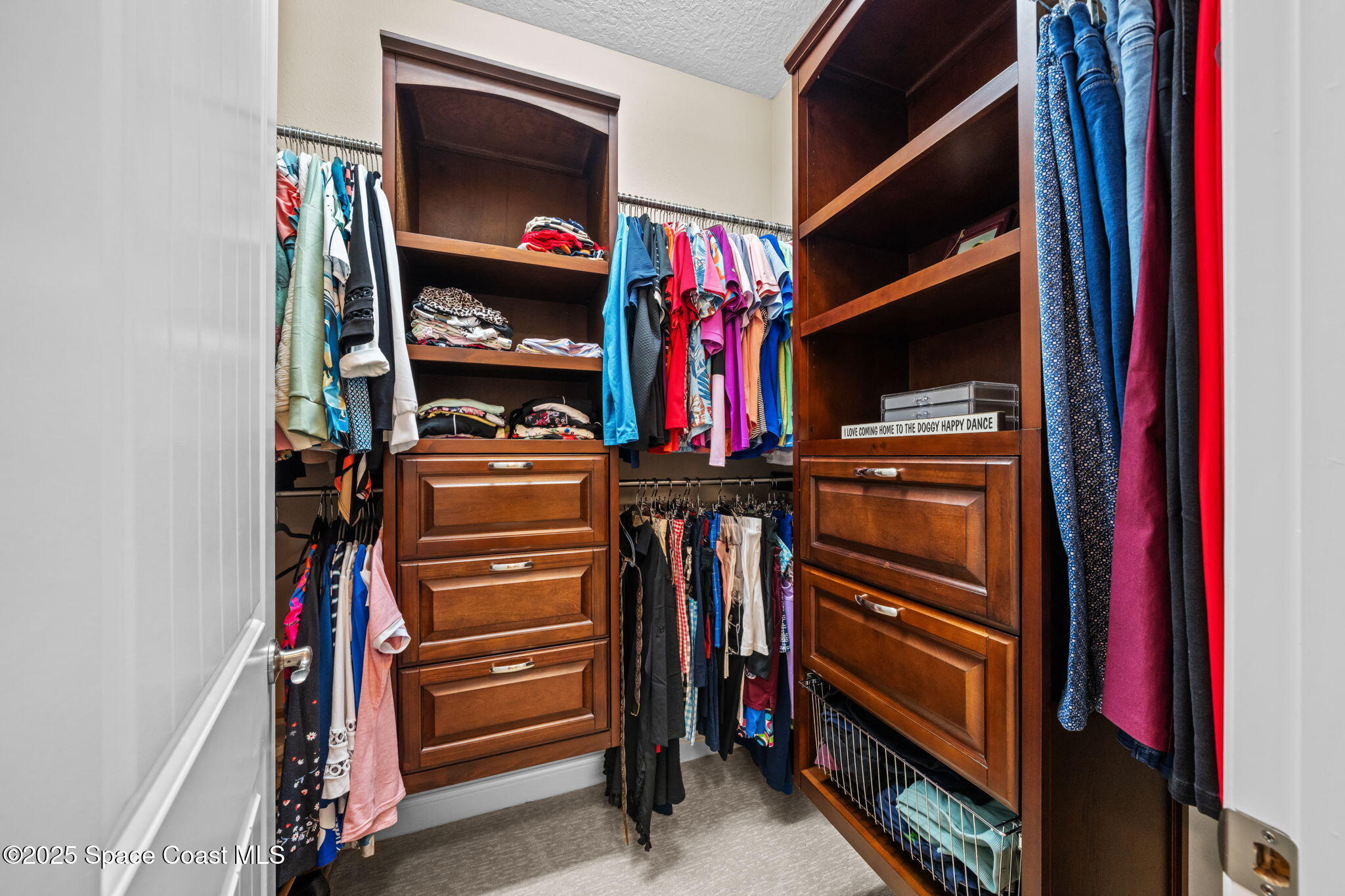 2803 Agilny Lane Melbourne, FL 32940 - Photo 35 of 65 a view of walk in closet with clothes and shoes