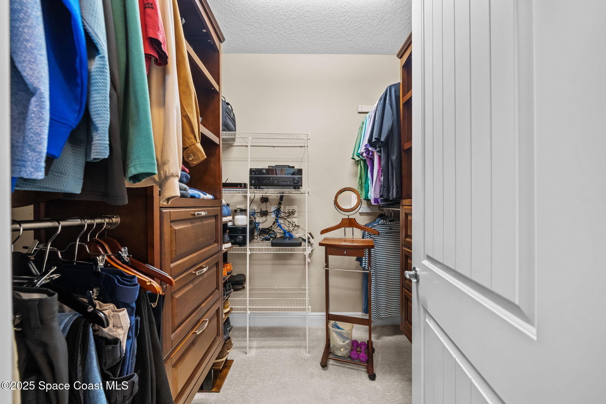 2803 Agilny Lane Melbourne, FL 32940 - Photo 36 of 65 a view of walk in closet with clothes and shoes