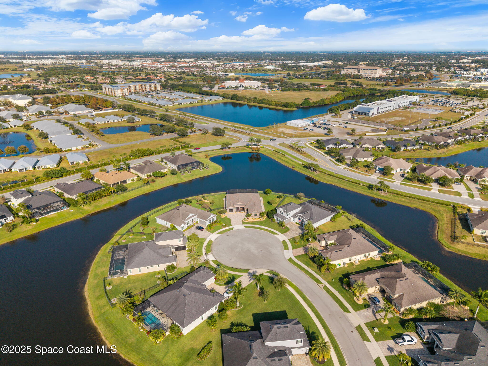 2803 Agilny Lane Melbourne, FL 32940 - Photo 55 of 65 an aerial view of a swimming pool with a table and chairs