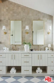 a bedroom with a bed potted plant on the dresser and a large window
