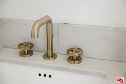 a large kitchen with stainless steel appliances granite countertop a stove a sink dishwasher a dining table and chairs with wooden floor