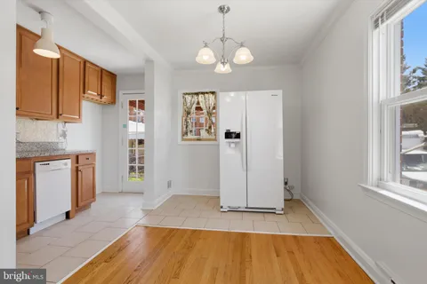 a view of a livingroom with wooden floor and a window