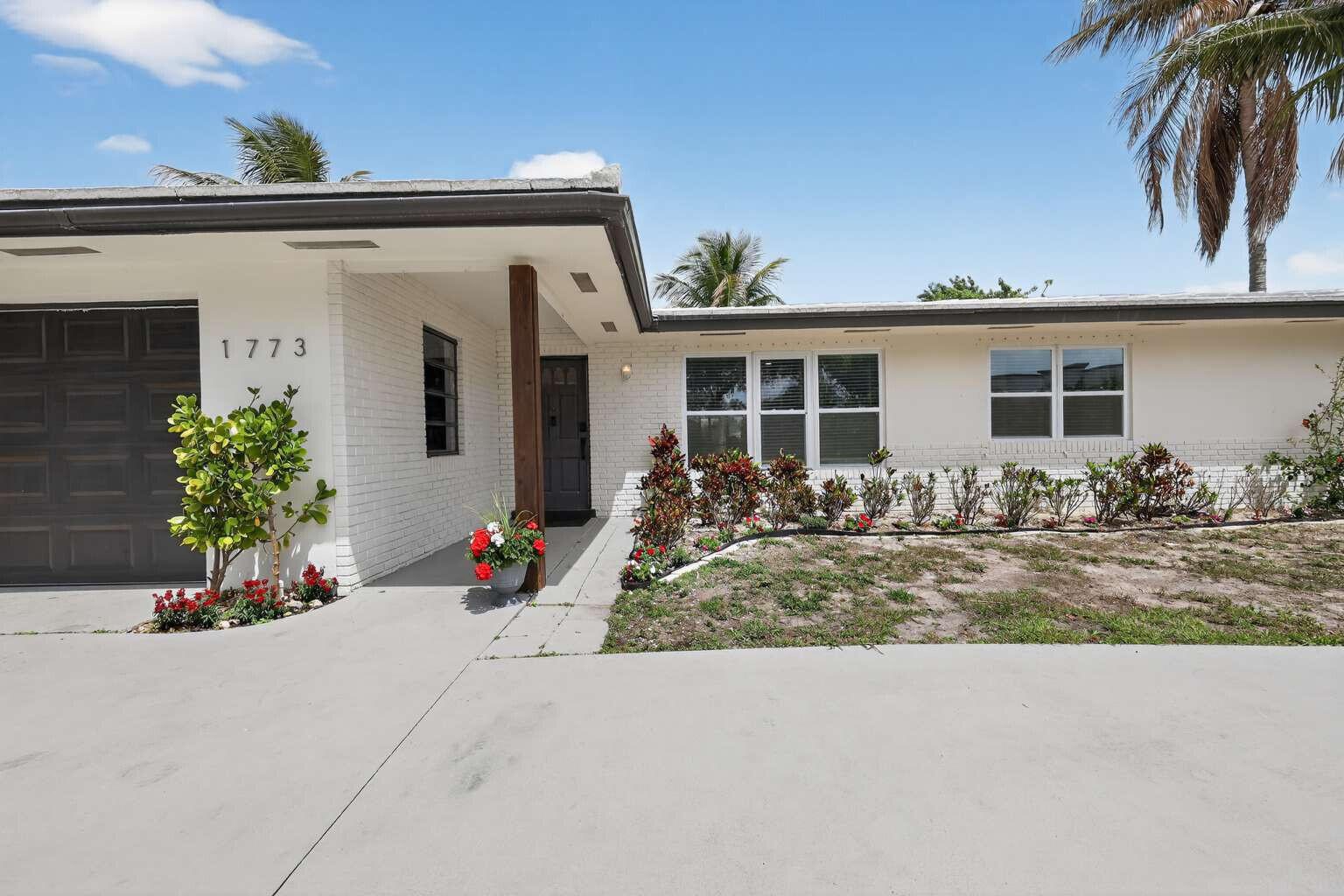 1773 Ocala Road North Palm Beach, FL 33408 - Photo 2 of 47 front view of a house with a patio