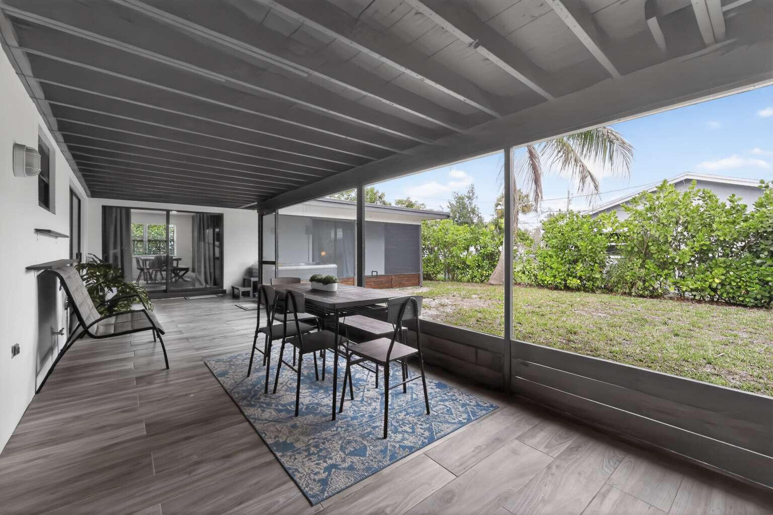 1773 Ocala Road North Palm Beach, FL 33408 - Photo 38 of 47 a view of a patio with table and chairs potted plants with wooden floor and fence