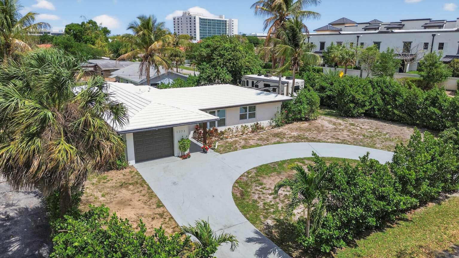 1773 Ocala Road North Palm Beach, FL 33408 - Photo 4 of 47 an aerial view of a house with a yard and trees